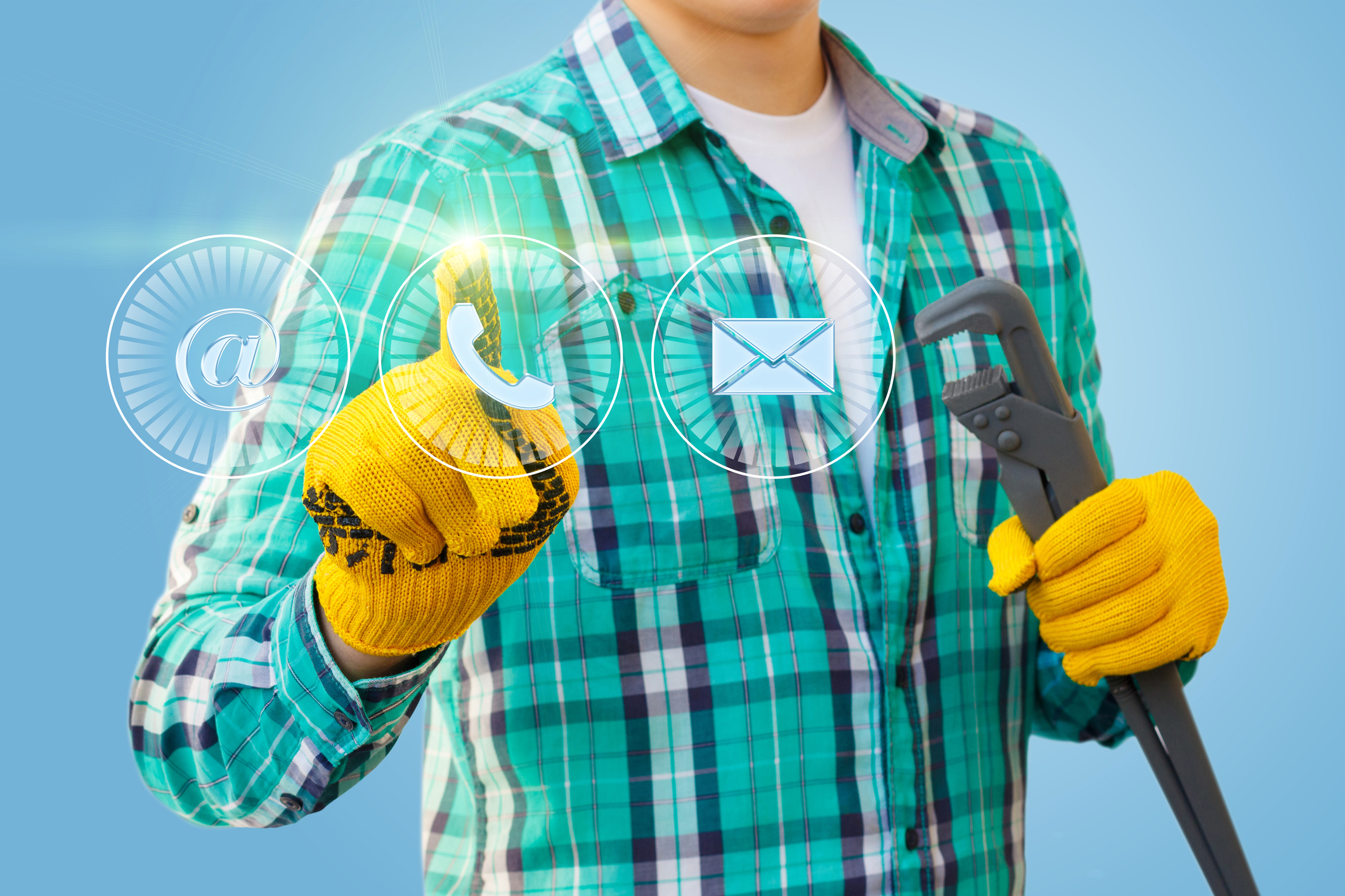 A person in a green plaid shirt and yellow gloves holds a pipe wrench and touches virtual icons for email, phone, and letter, symbolizing contact options, against a blue background.
